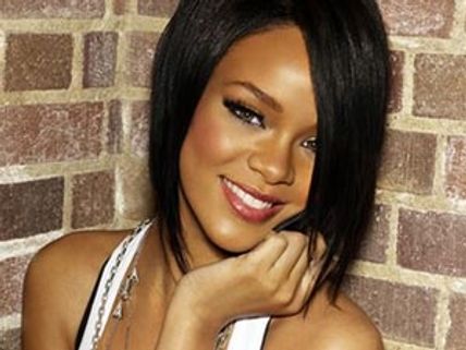 Rihanna grabs her bum on stage