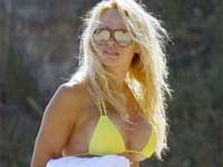 Pamela hits Malibu beach in yellow bikini