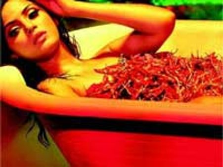Neetu plunges into a tub of red chillies!