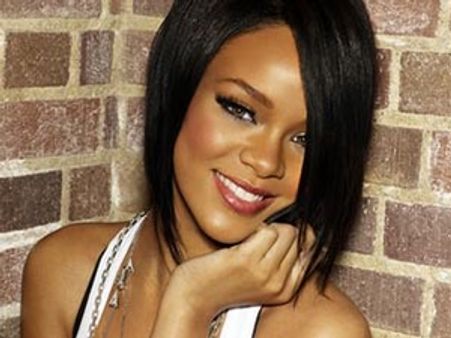 Rihanna grabs her bum on stage