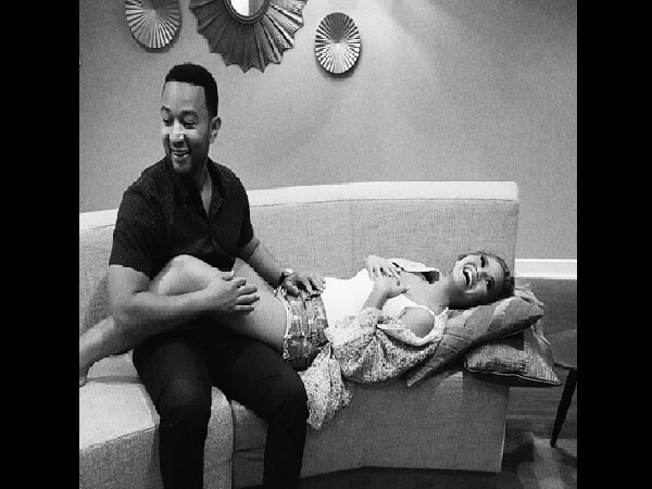 John Legend lying on wife Chrissy's lap