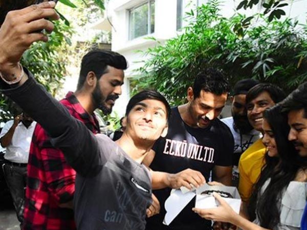 John Cuts Cake With Fans