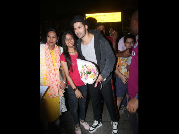 Varun Dhawan Receives A Bouquet Of Flowers From A Fan