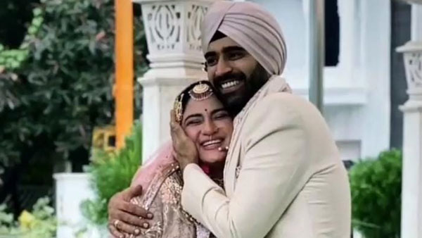 Groom hugs the bride