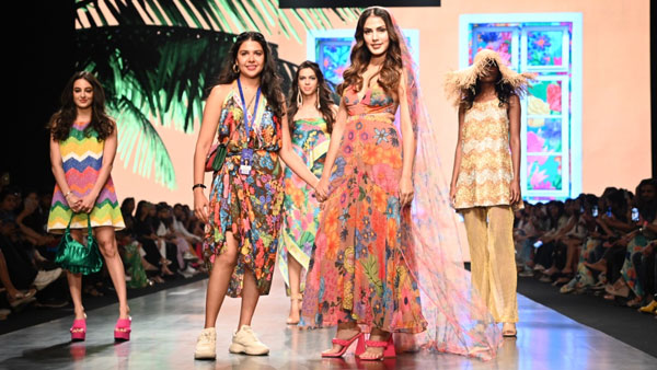 Rhea poses with the designer