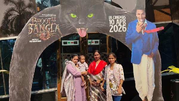 Excited Theatre Audience Pose Next to Bhooth Bangla Posters Excited Theatre Audience Pose Next to Bhooth Bangla Posters