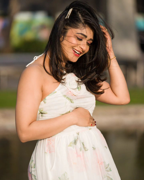 Aditi Prabhu Deva in a white floral midi dress.