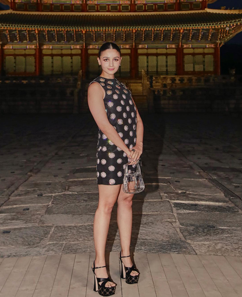 Alia Bhatt with a knee-length black dress.