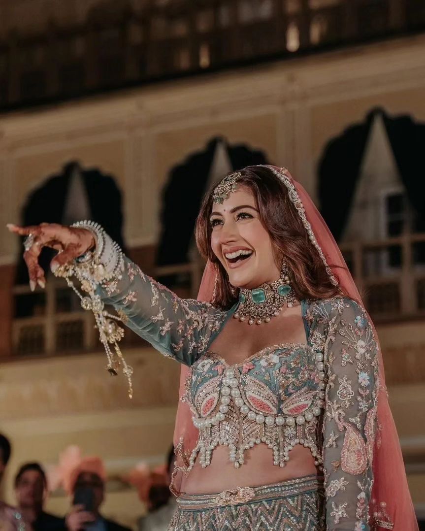 Karan Sharma opted for a silver sherwani paired with matching pyjamas.