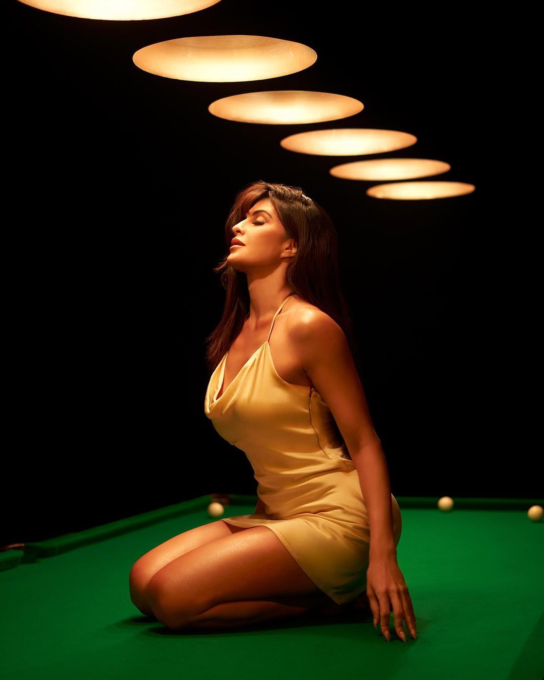Jacqueline Fernandez effortlessly exudes elegance in a pristine white dress, a vision of grace