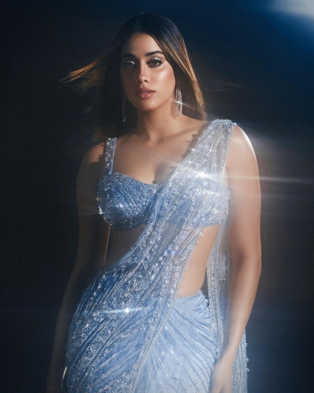 Janhvi Kapoor takes our breath away in a shimmery ice blue saree, embodying grace and glamour.