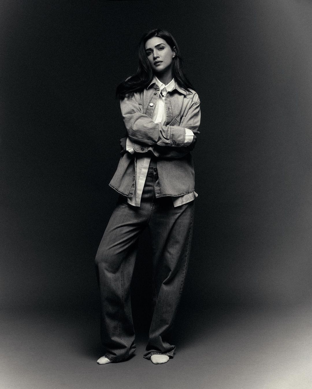 Kriti Sanon paired a white shirt with an open denim shirt and baggy blue denim trousers.