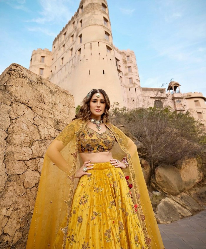 Nargis emanates regal elegance in a resplendent yellow ochre lehenga