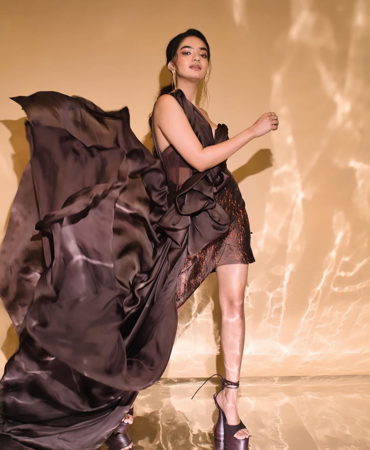 Anushka made a striking appearance at the Elle Awards in a captivating brown tassel dress adorned with a cascading front bow, elegantly paired with sky-high stilettos.