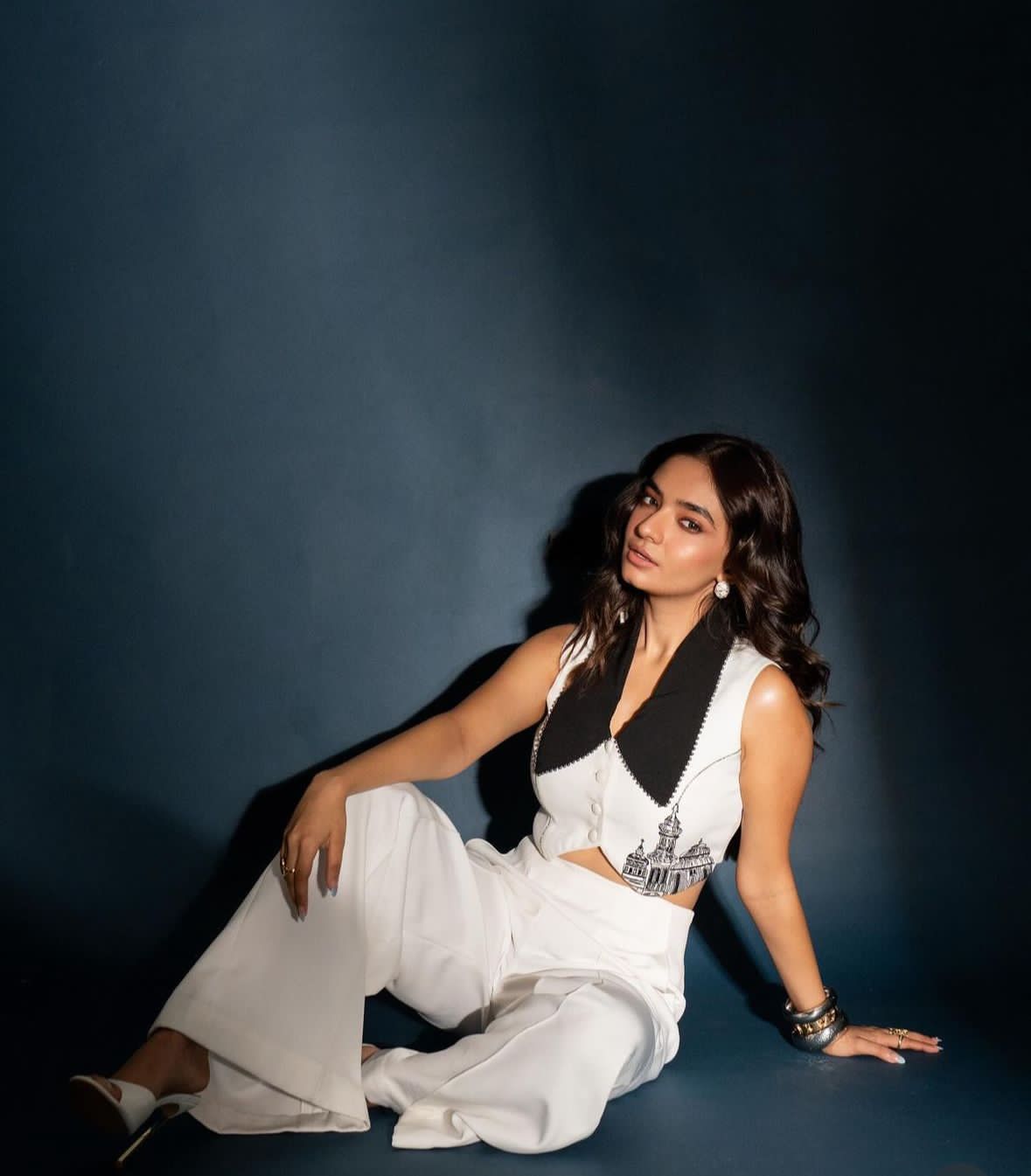Anushka skillfully blended power dressing with a touch of whimsy in a white crop blouse and trousers ensemble.