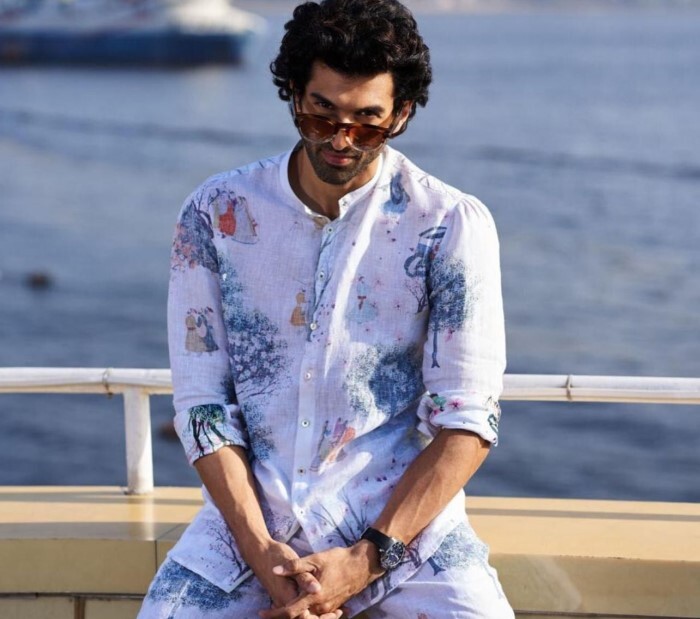 Aditya stuns in a white cotton shirt adorned with blue motifs