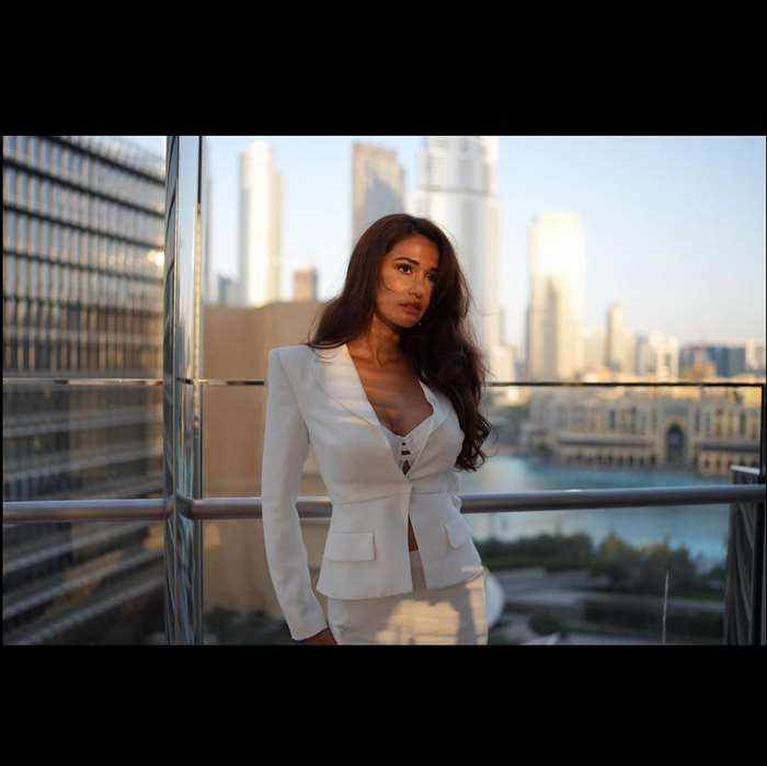 padded shoulders, and a cropped hem.