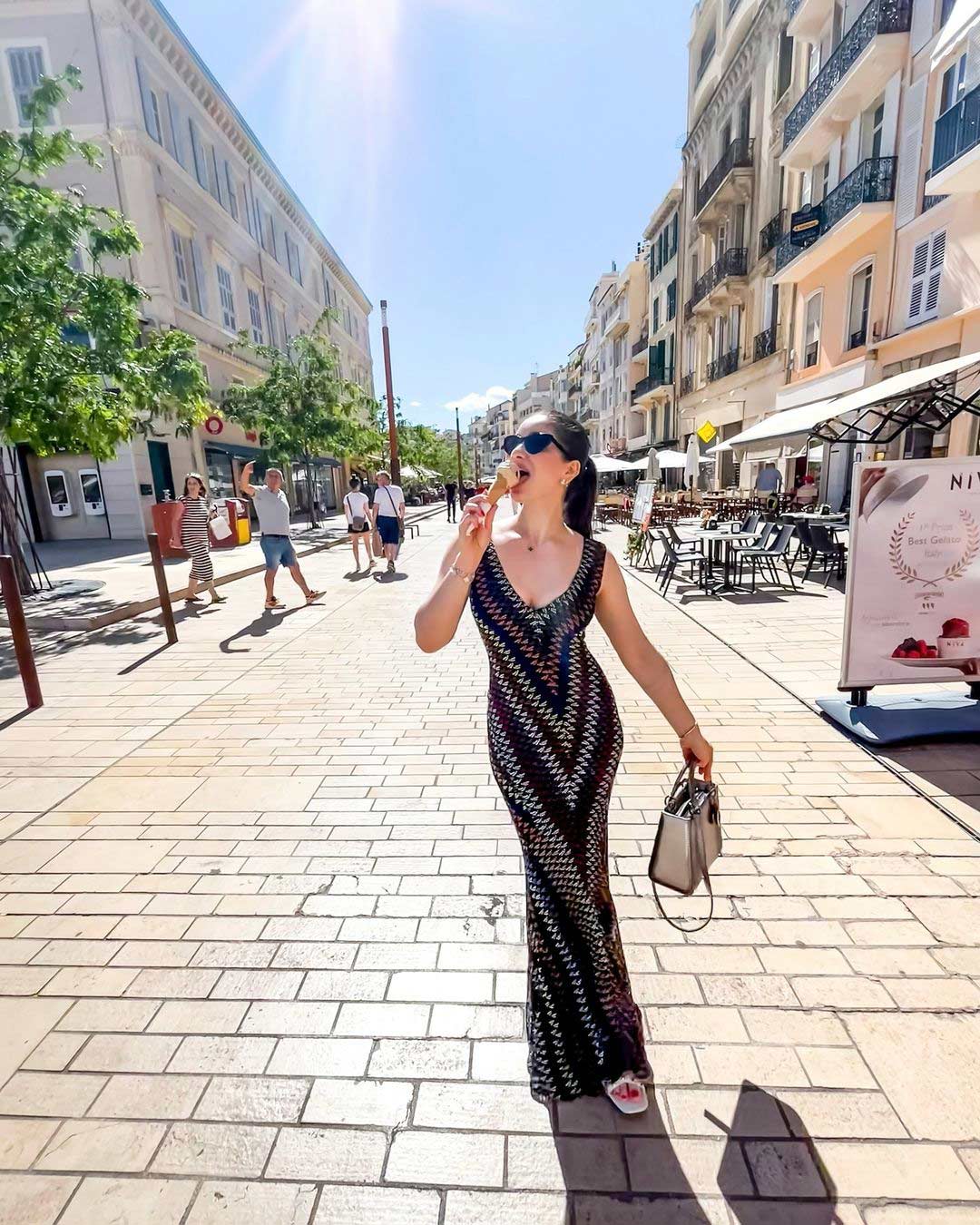 Sara enjoying her time, indulging in gelato and basking in the sun.