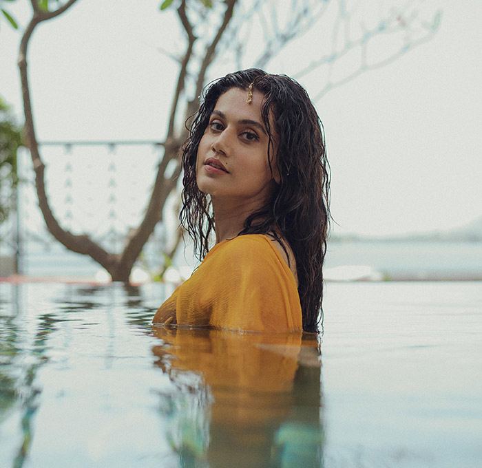 Taapsee exudes sensuous charm as she gracefully sports a wet yellow saree