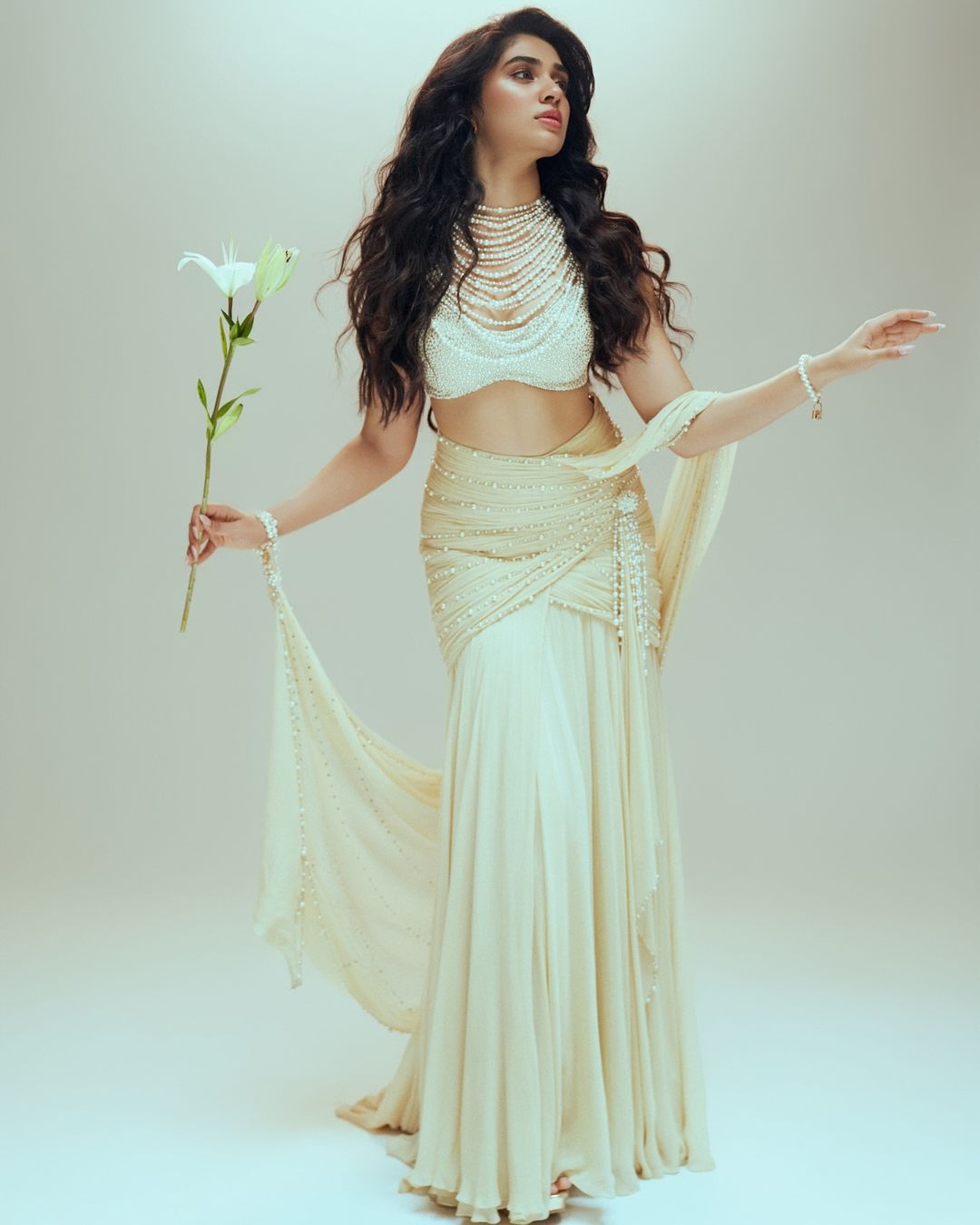Krithi Shetty dazzles in a Tarun Tahiliani pearl-adorned saree.