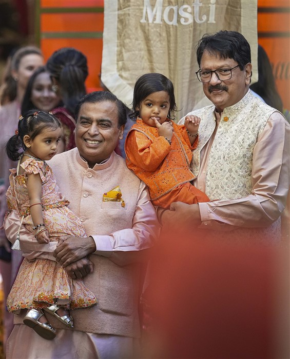 Reliance Industries Chairman Mukesh Ambani with his grandchild and others during a pre-wedding ceremony