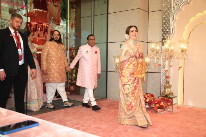 White Nita Ambani matched with her son in a similar colored exquisite saree, Mukesh Ambani opted for a baby pink Sherwani.