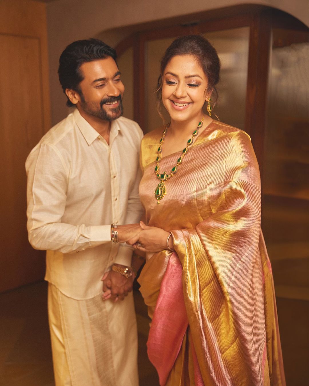 Suriya in traditional silk veshti and Jyothika saree attire.