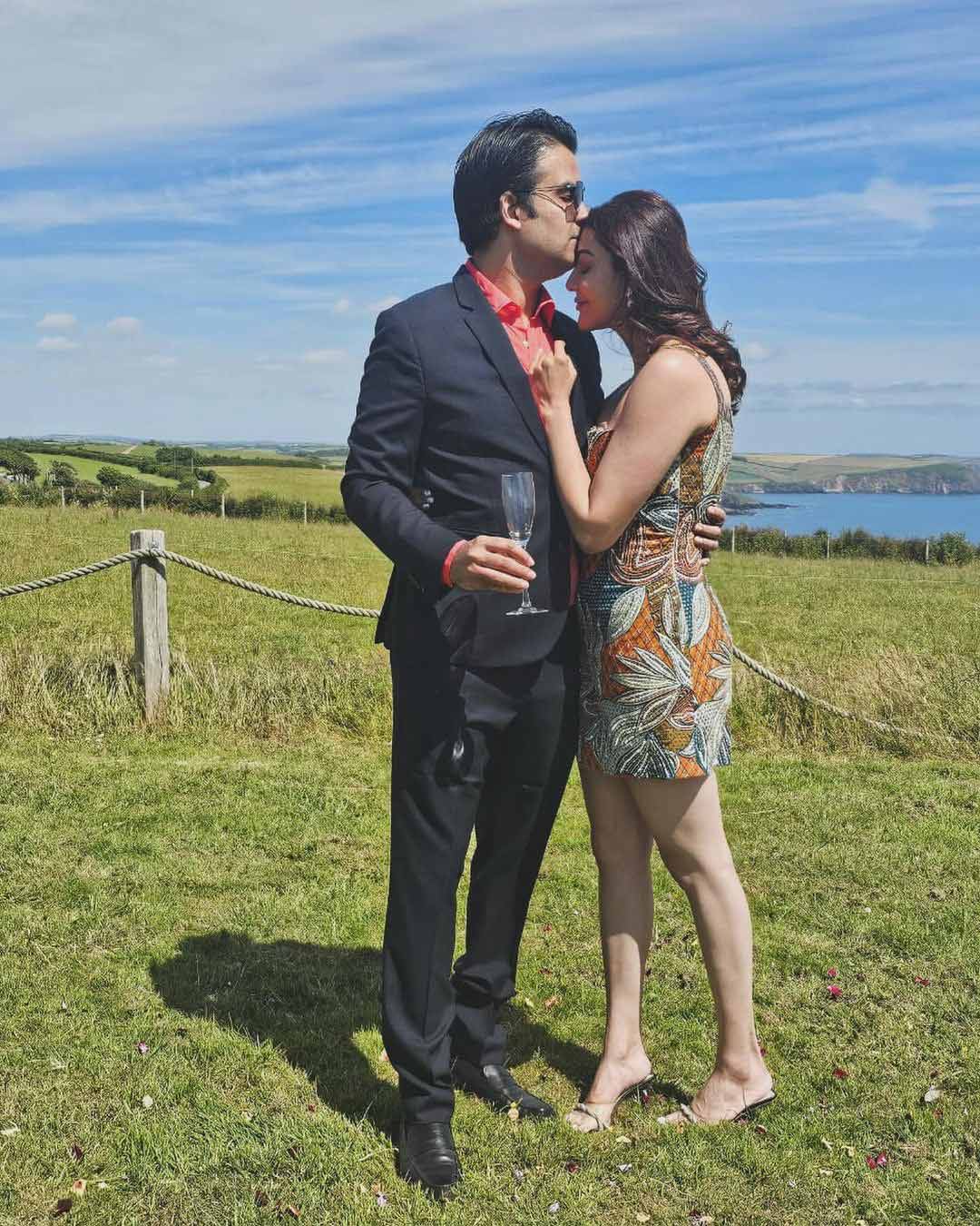 Kajal received a passionate forehead kiss from her husband amidst a beautiful landscape.