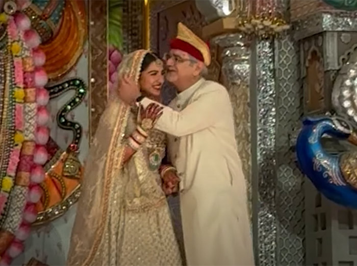 Radhika Merchant shares a candid moment with her father as she makes her entry.