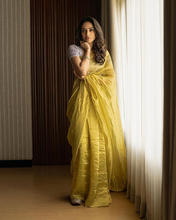 Draped in a yellow saree, the actress effortlessly embodies the essence of simplicity and sheer charm, showcasing a truly stunning appearance.