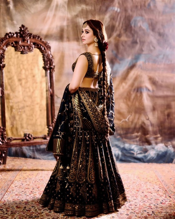 Tamannaah Bhatia captivates in a luxurious black and gold lehenga, turning heads everywhere