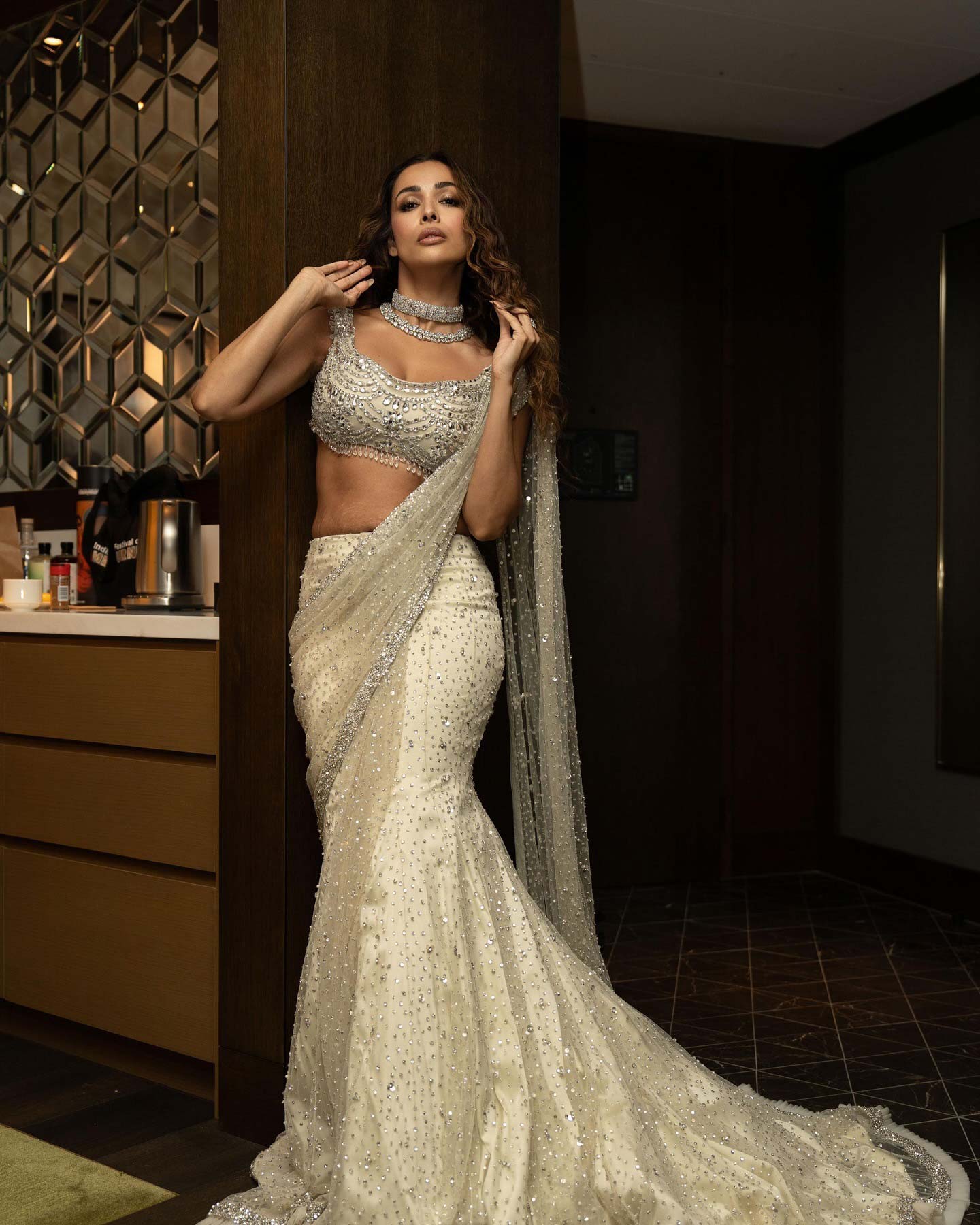 Malaika Arora's lehenga features intricate sequin embroidery with floral designs in silver and pale pink