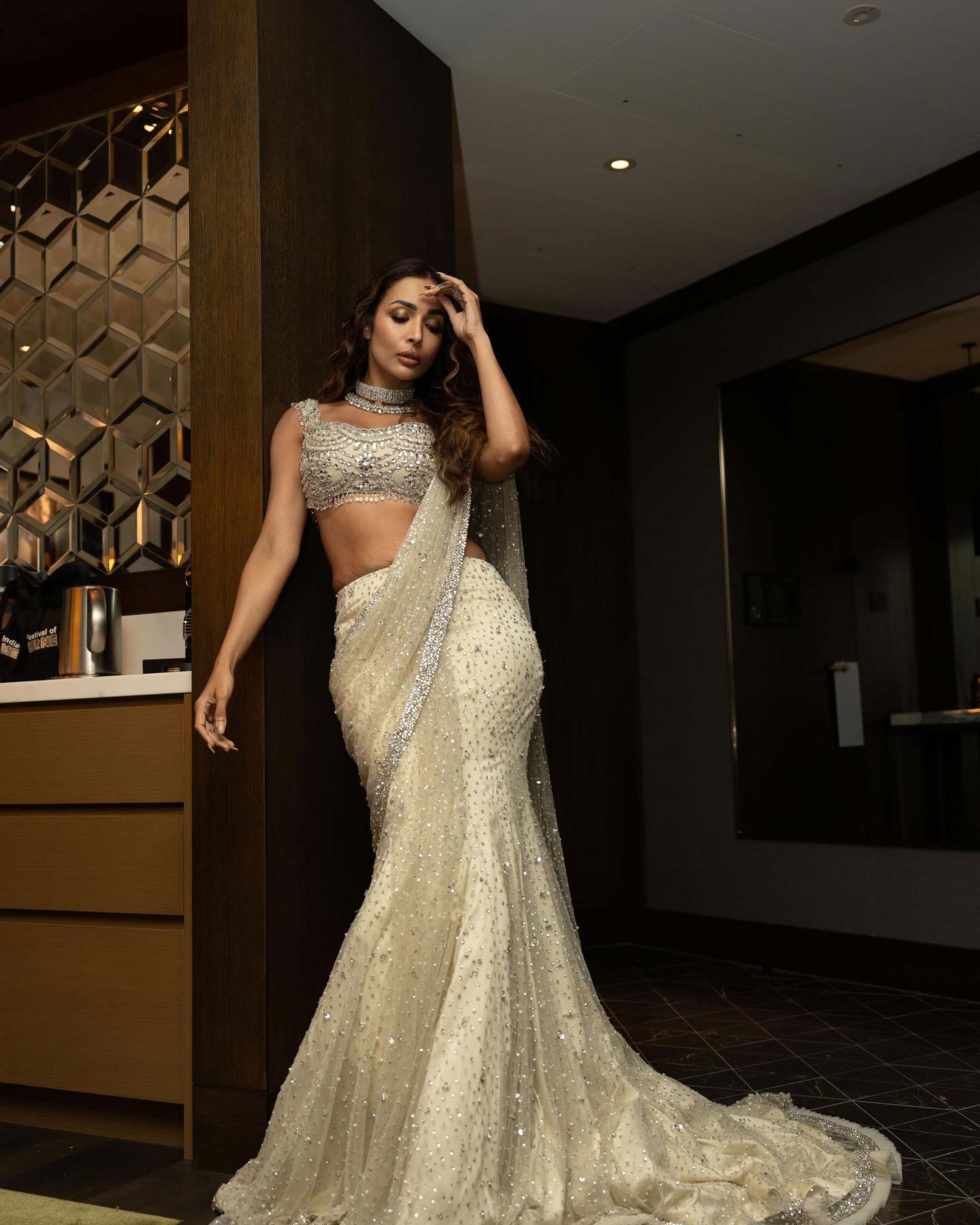 Malaika Arora's lehenga features intricate sequin embroidery with floral designs in silver and pale pink