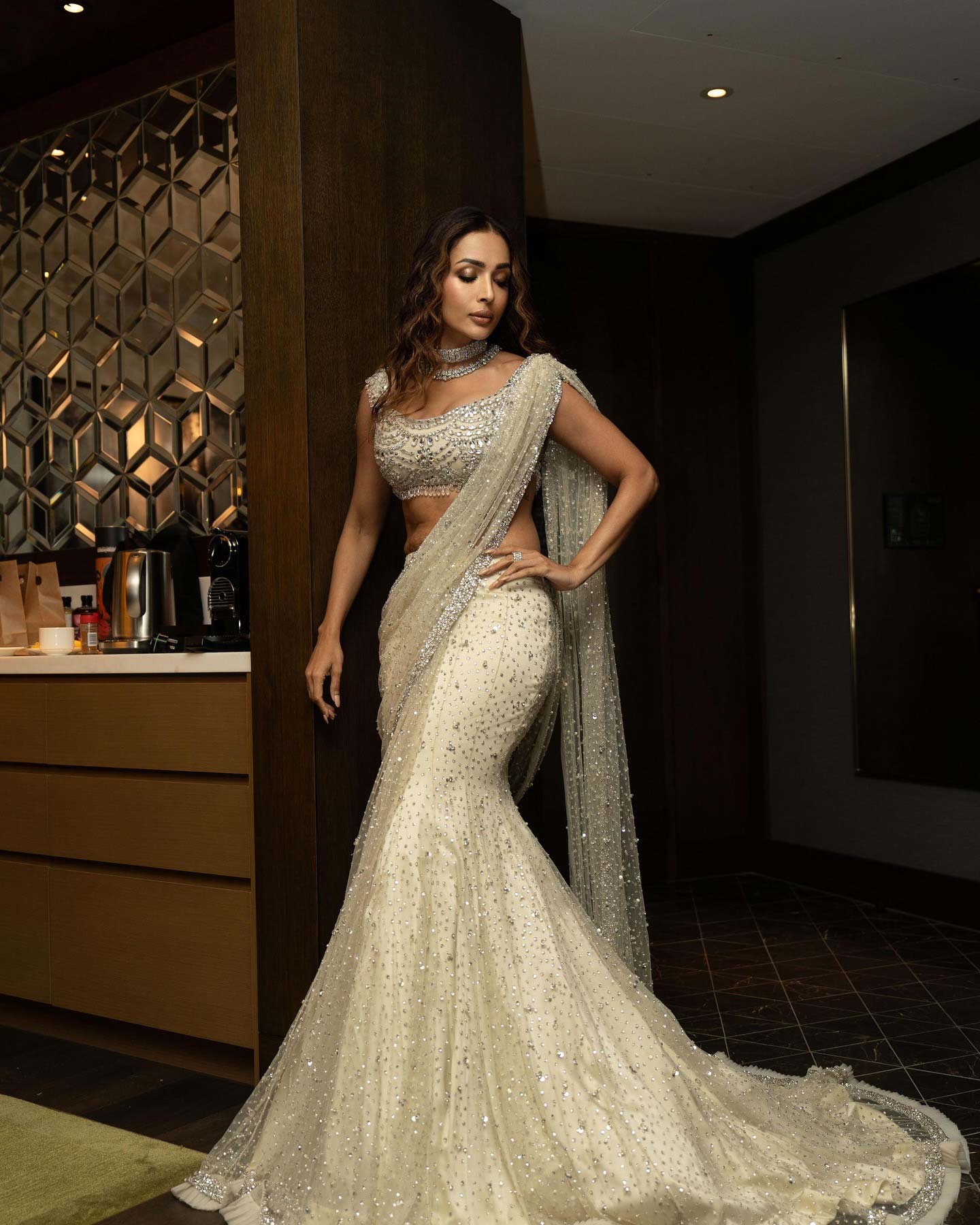 Malaika Arora's lehenga features intricate sequin embroidery with floral designs in silver and pale pink