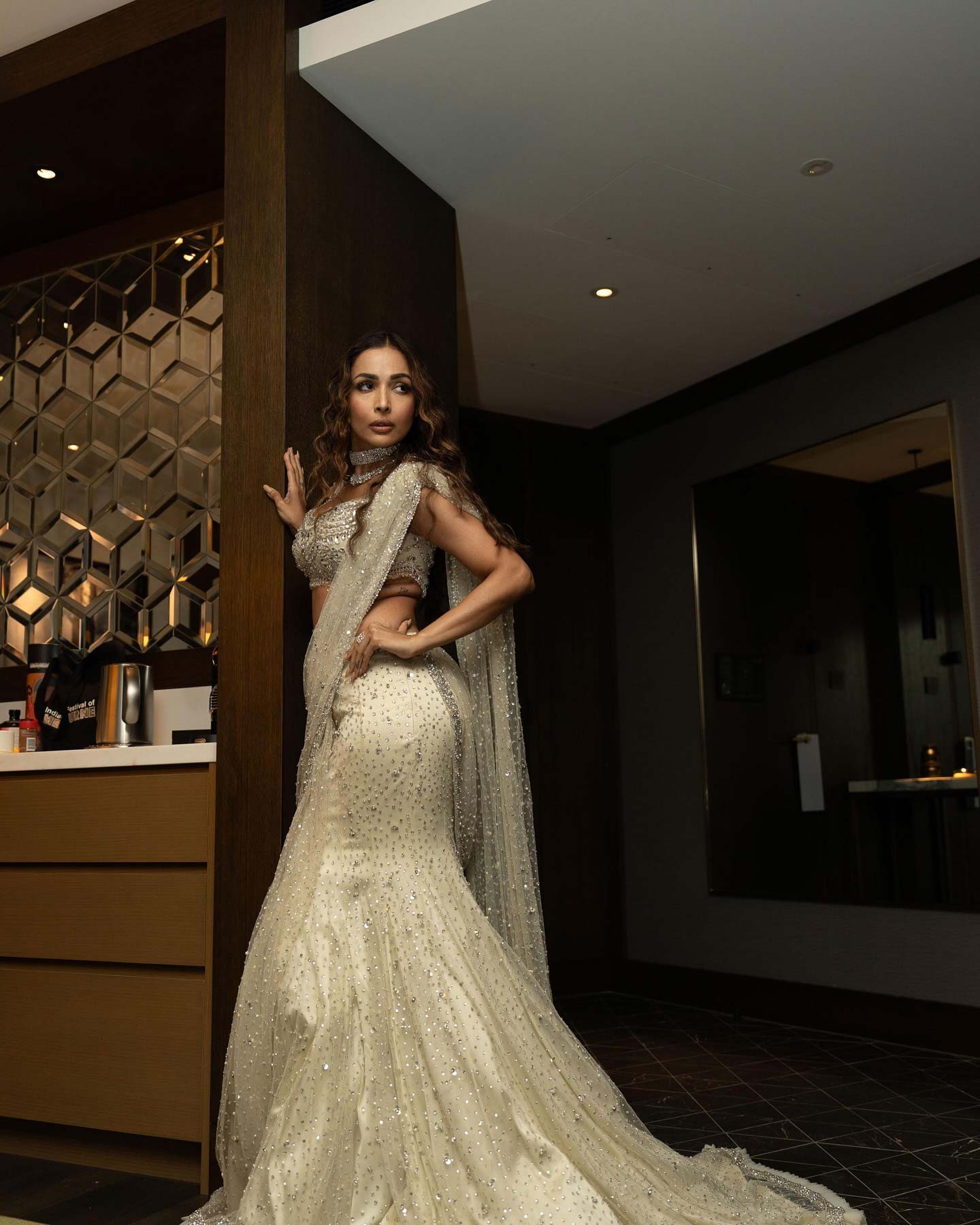 Malaika Arora's lehenga features intricate sequin embroidery with floral designs in silver and pale pink