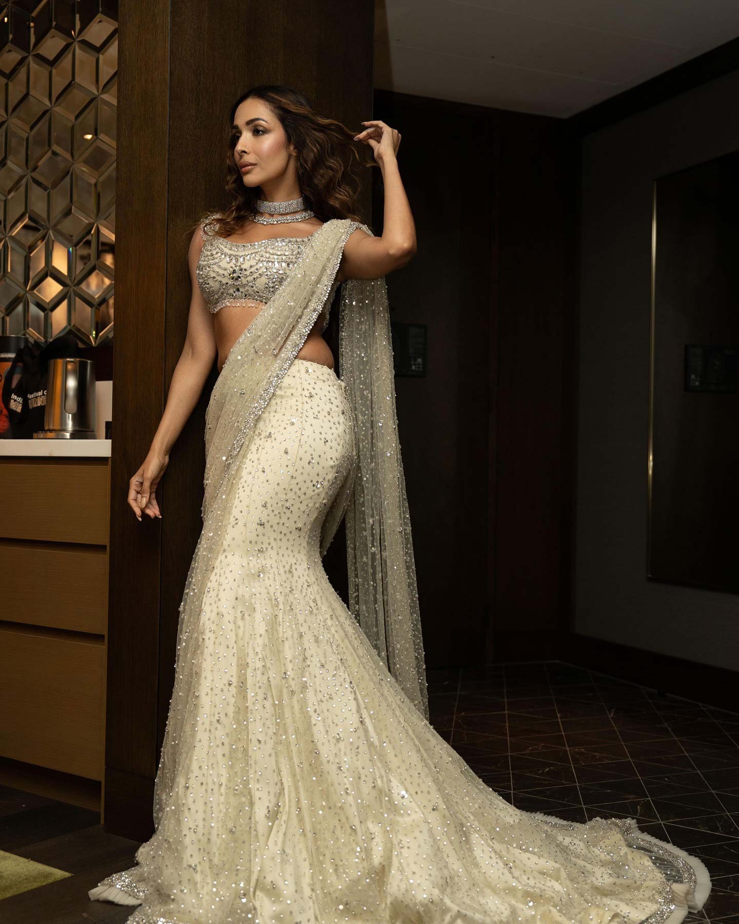 Malaika Arora's lehenga features intricate sequin embroidery with floral designs in silver and pale pink