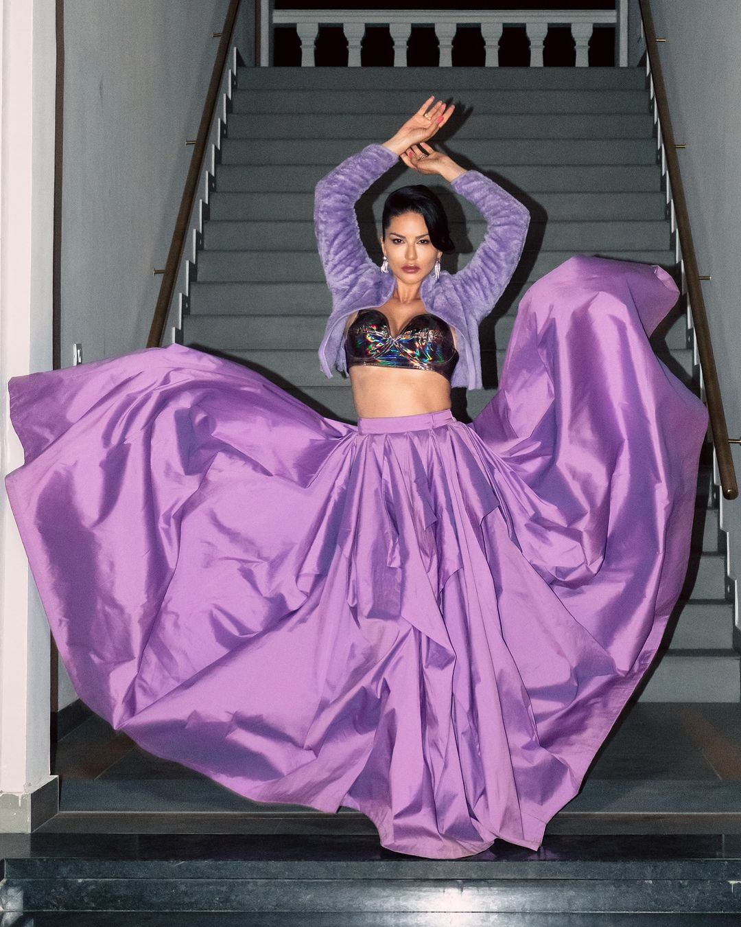 Sunny stuns in a purple low-neck bralette jacket paired with a matching skirt, exuding bold elegance