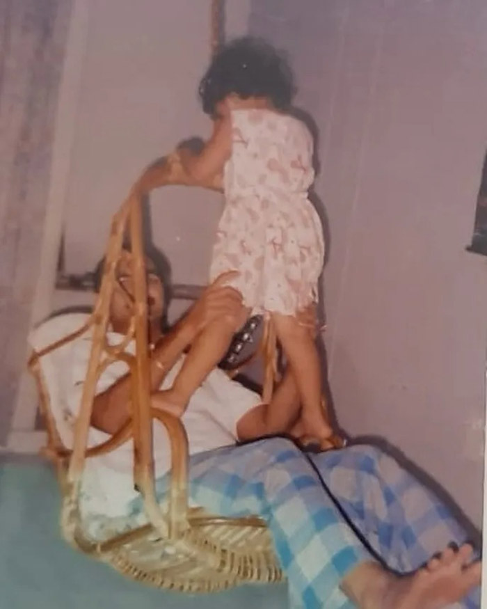 There’s a photo of her playing on a swing with her father, capturing a joyful moment.