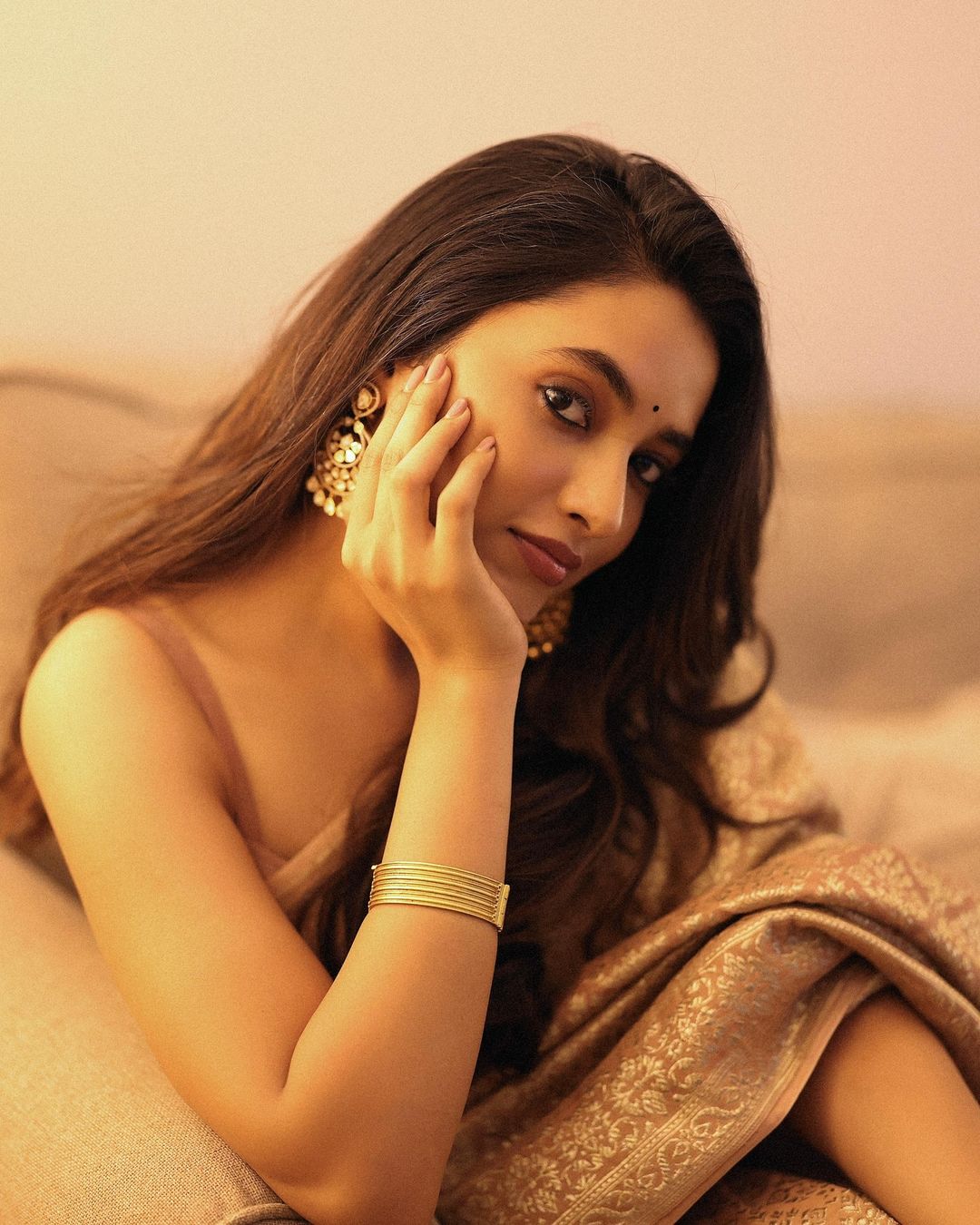 Priyanka Mohan is draped in a stunning beige silk saree