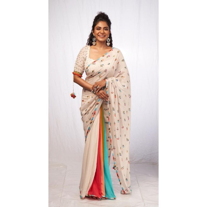 Poornima Indrajith's vibrant printed saree is an excellent alternative to the traditional kasavu for Onam. She styled it with half-updid hair and oversized earrings for a bold yet elegant look.