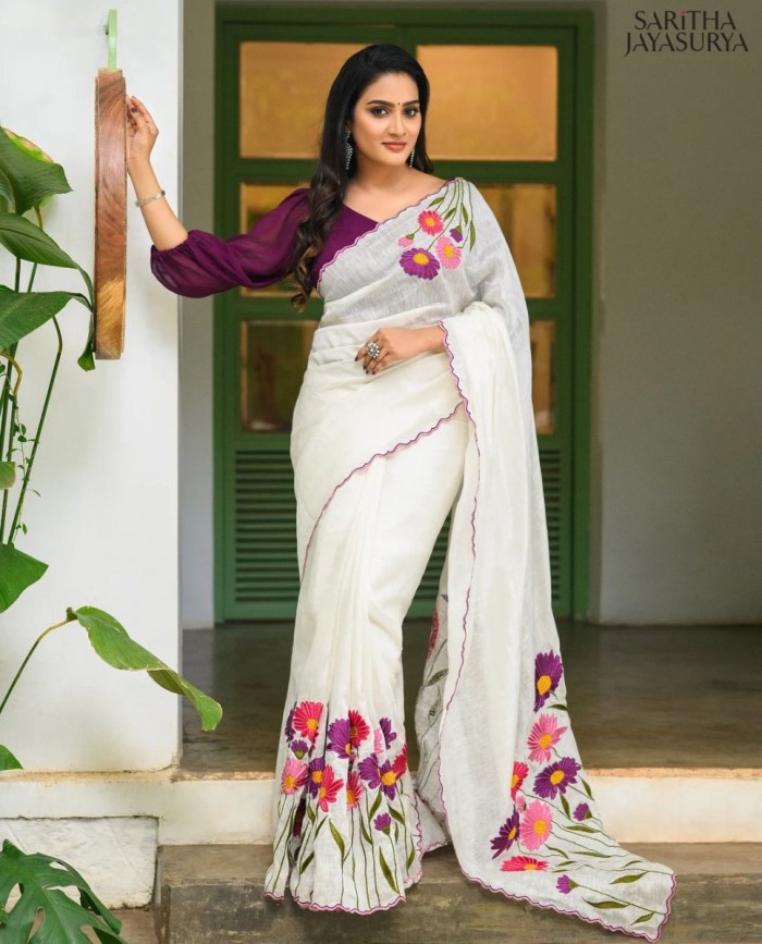 If you're not looking for the traditional Kerala saree, Aditi Ravi's saree with floral thread work and balloon sleeve blouse offers a stylish choice for the festive season