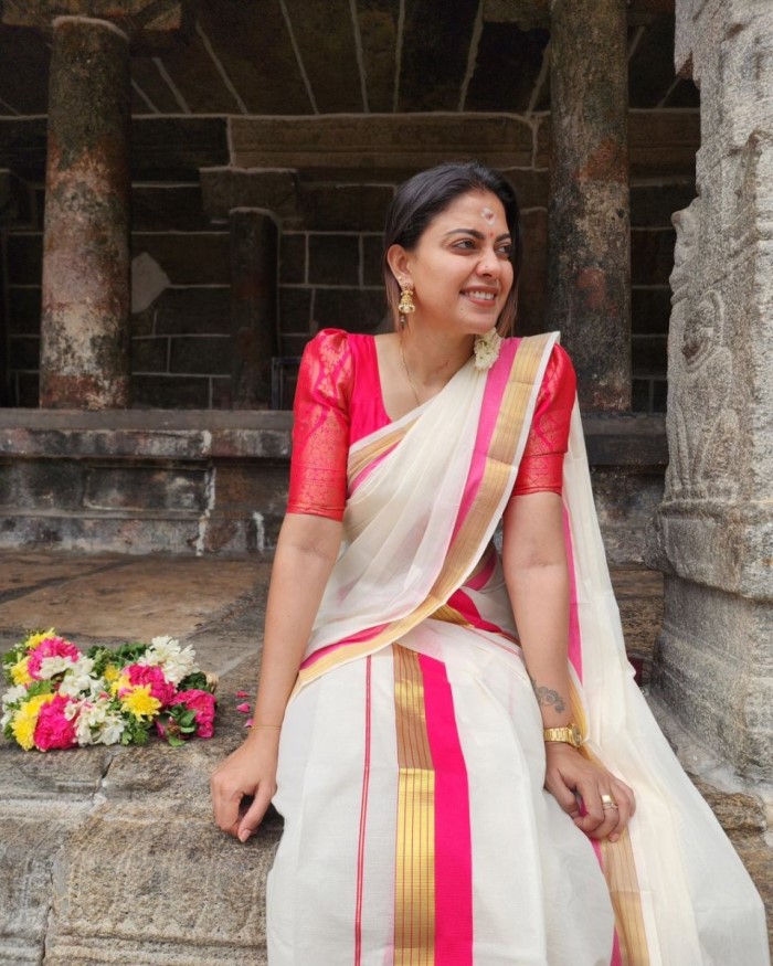 If you're unsure about wearing a saree, try Anusree's settum mundum with red and golden borders paired with a brocade blouse – an apt choice for stealing the spotlight during Onam festivities.