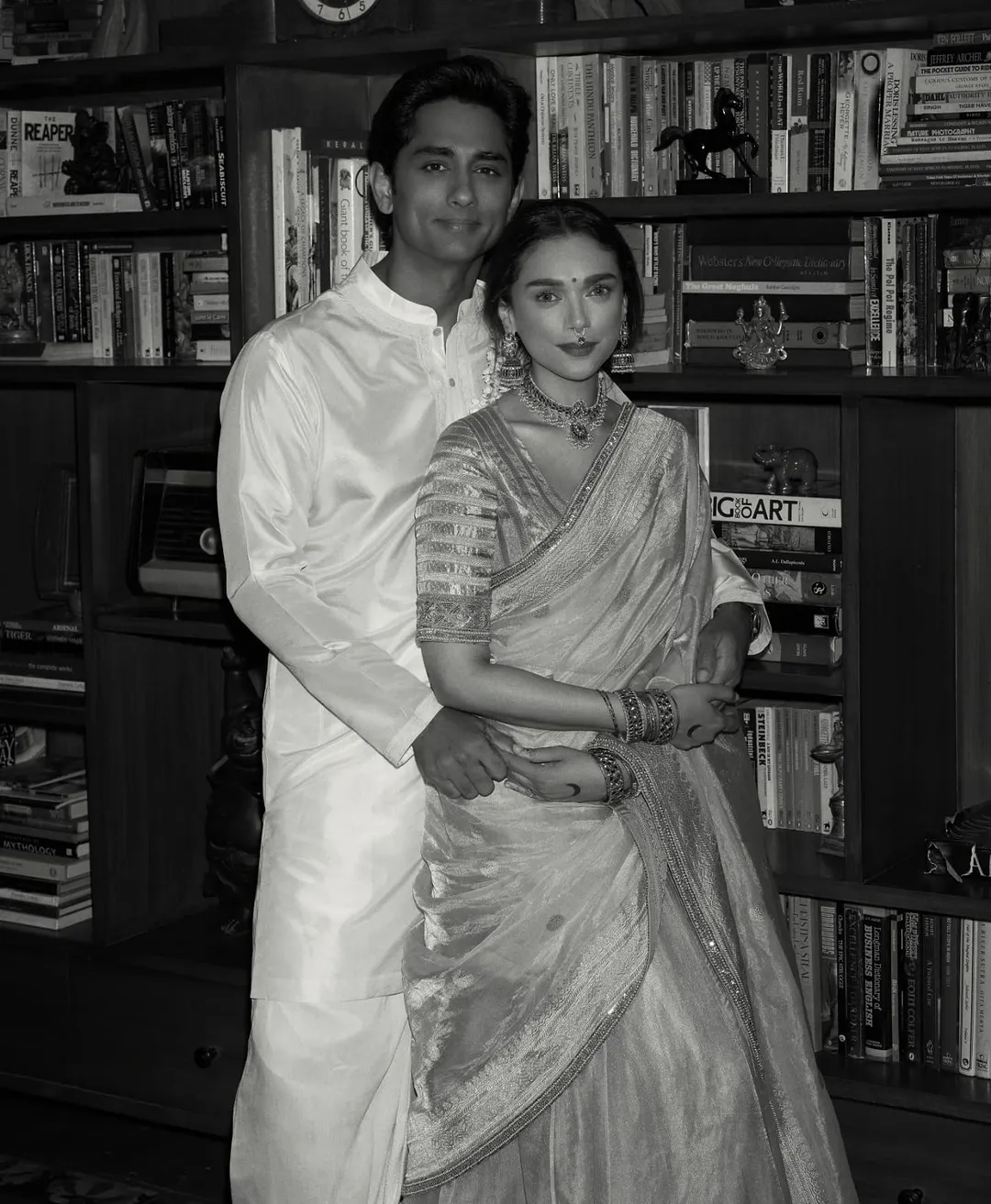 Aditi wore a beige silk saree with simple makeup and traditional temple jewelry, while Siddharth complemented her in cream and gold.