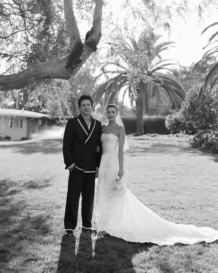 Brooke wore a custom Danielle Frankel strapless gown, while Charlie opted for a custom Bode double-breasted suit jacket with lace trim.