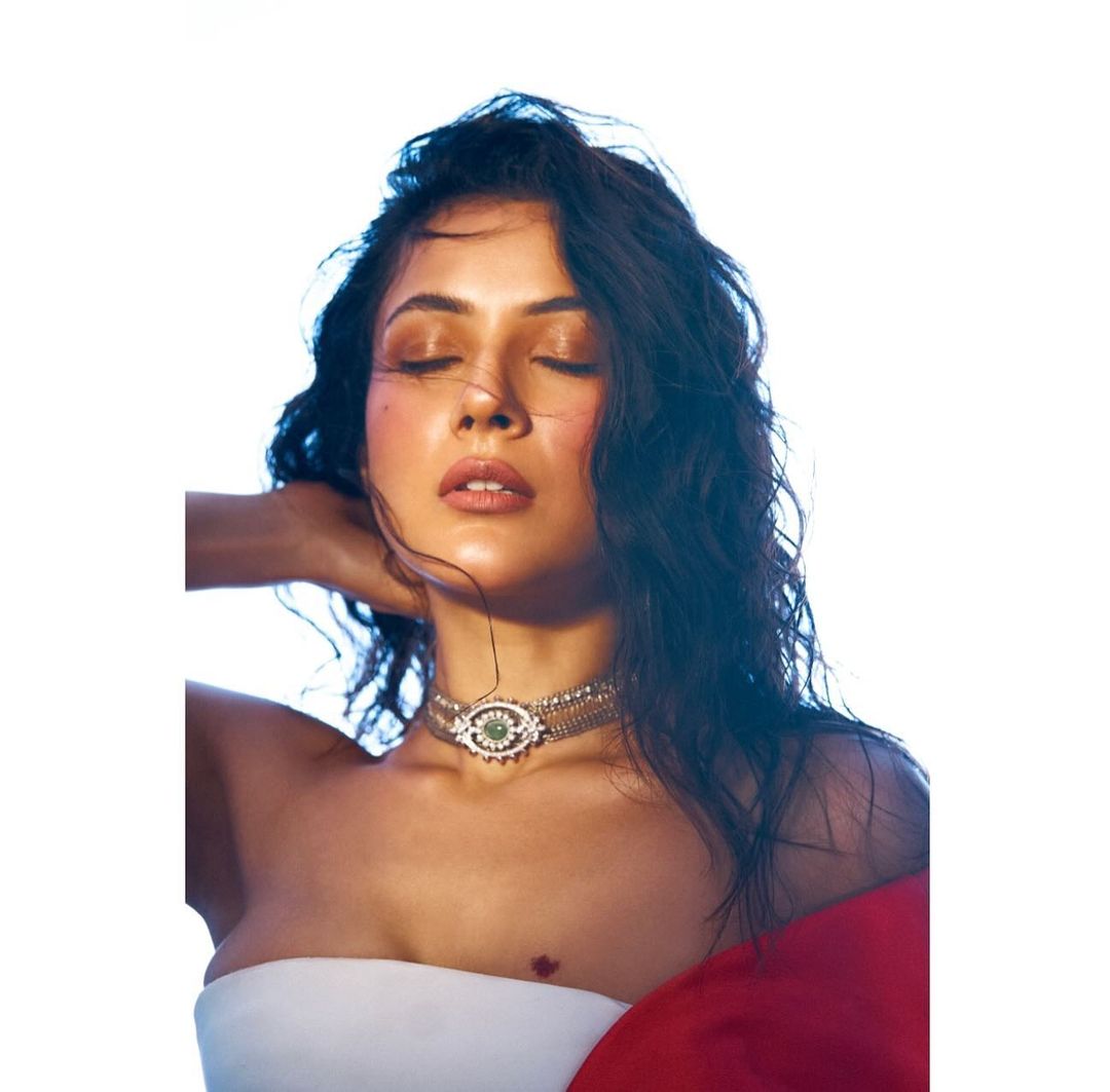 Shehnaaz Gill wore a chic white tube short dress paired with a striking red cape.
