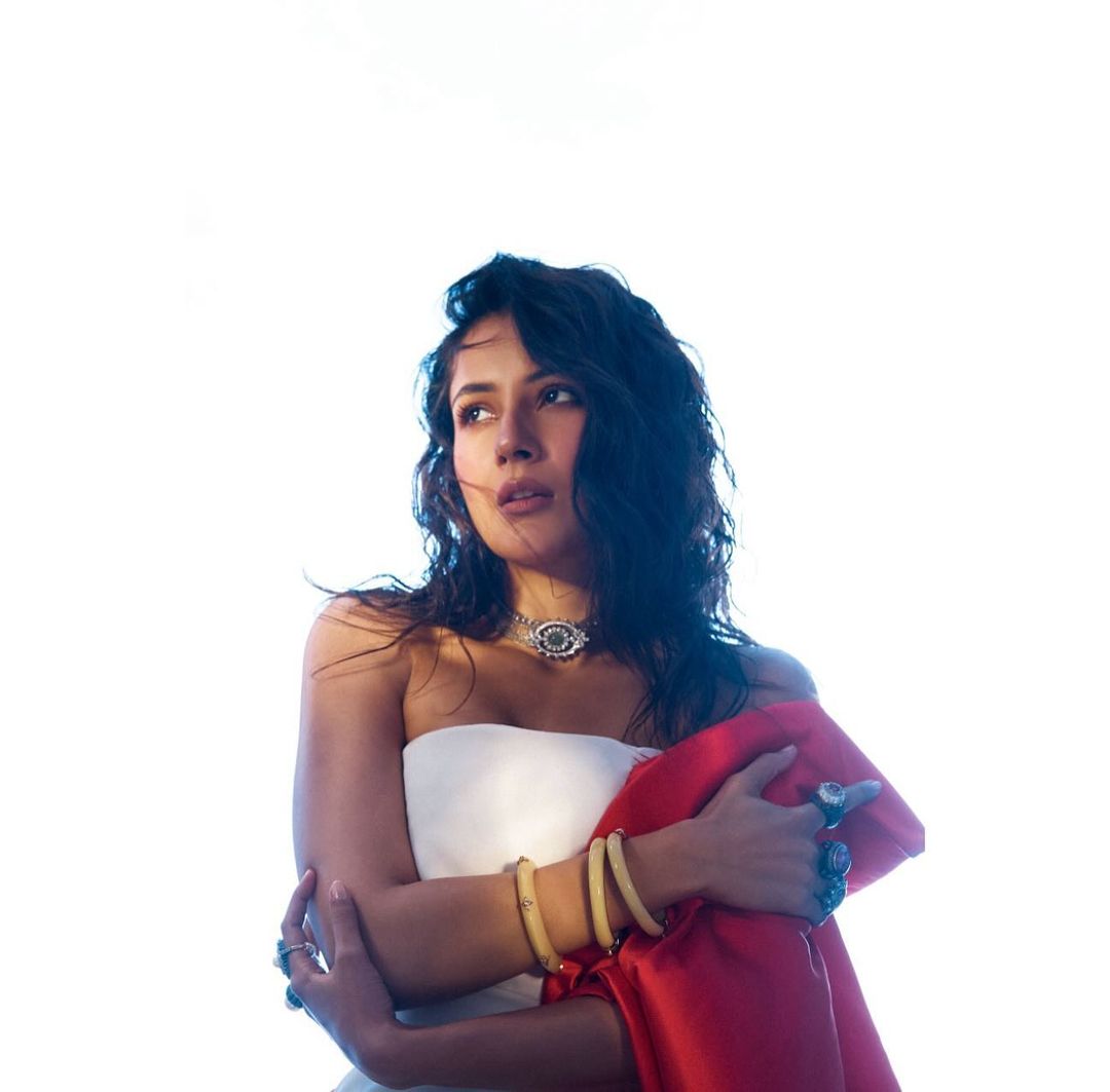 Shehnaaz Gill wore a chic white tube short dress paired with a striking red cape.