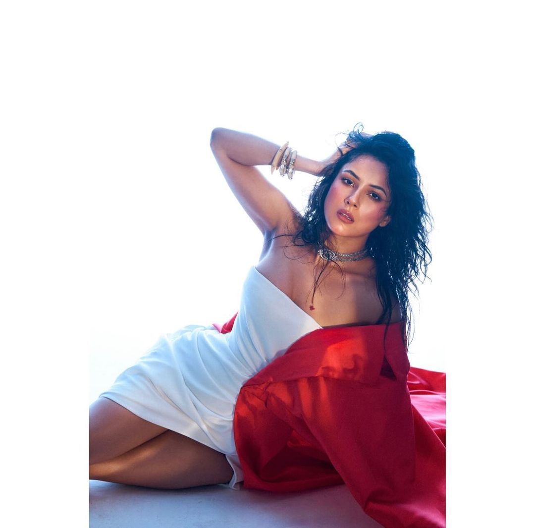 Shehnaaz Gill wore a chic white tube short dress paired with a striking red cape.