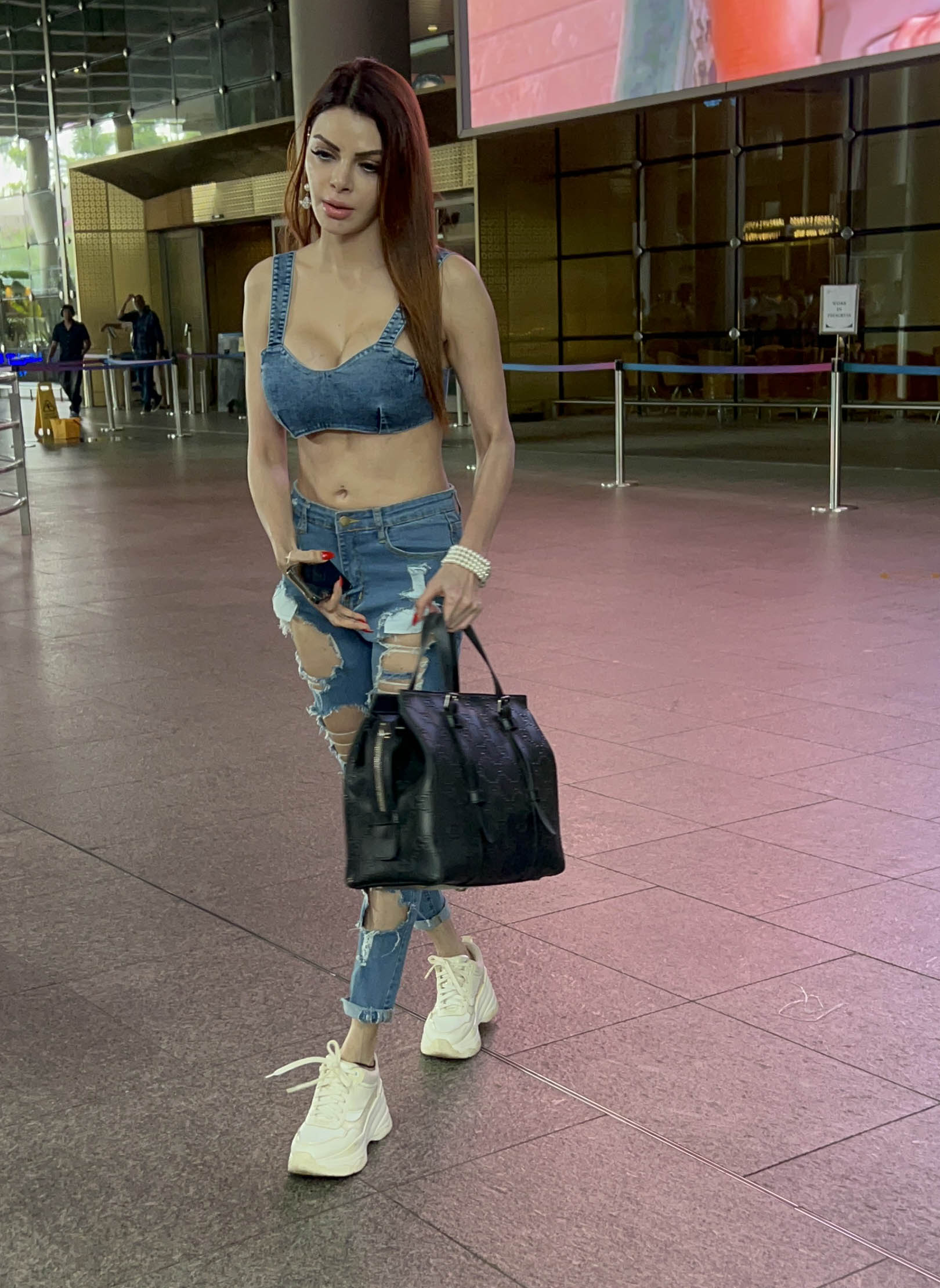 Sherlyn Chopra wore a pair of torn denim jeans paired with a sleeveless denim top and spotted at Mumbai Airport