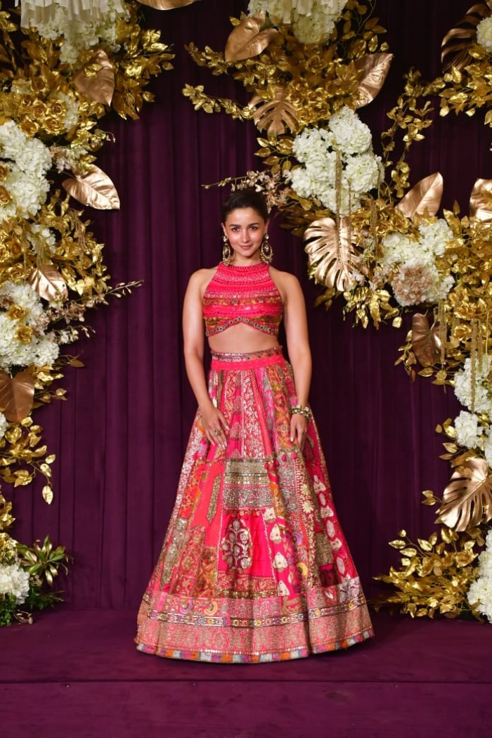 The sleeveless cropped blouse combined with a flowy lehenga adds a modern, chic element while keeping the traditional charm alive.