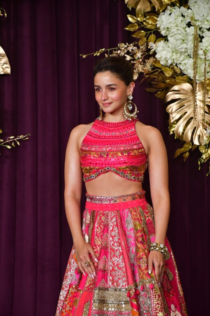 She kept her accessories subtle yet impactful, pairing the outfit with elegant statement earrings and a bracelet, maintaining a balanced look.